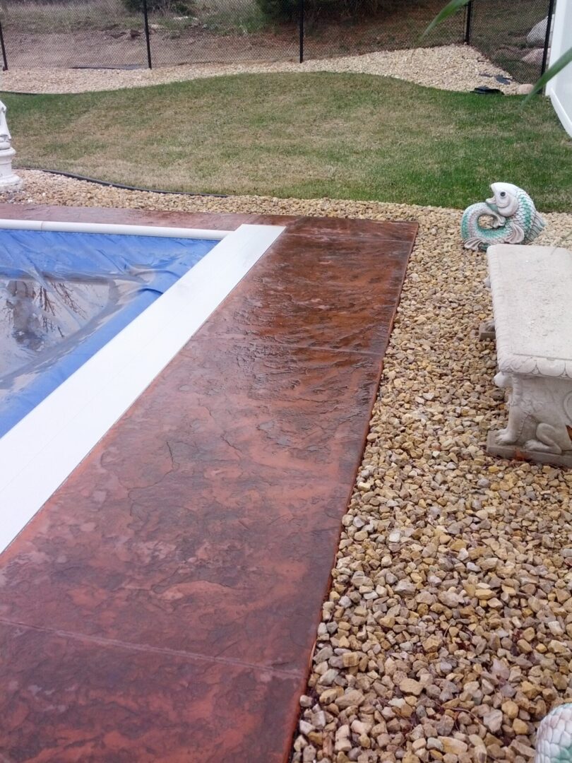Dark-brown stone flooring surrounding the pool area