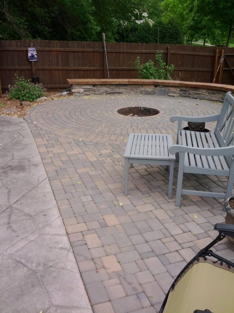 Stonework on outdoor firepit with a grey-blue outdoor chair