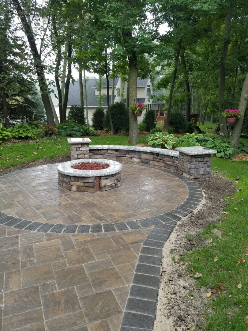 Brown stone flooring leading toward a bricked firepit area