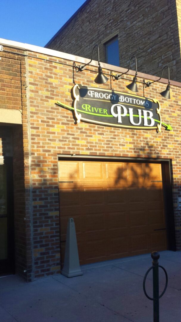 Olive-colored brick storefront of a pub